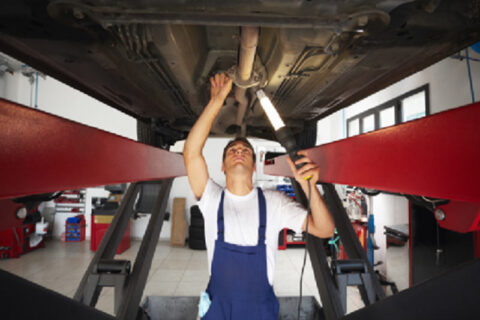 MAN WORKING ON FLOORING OF CAR