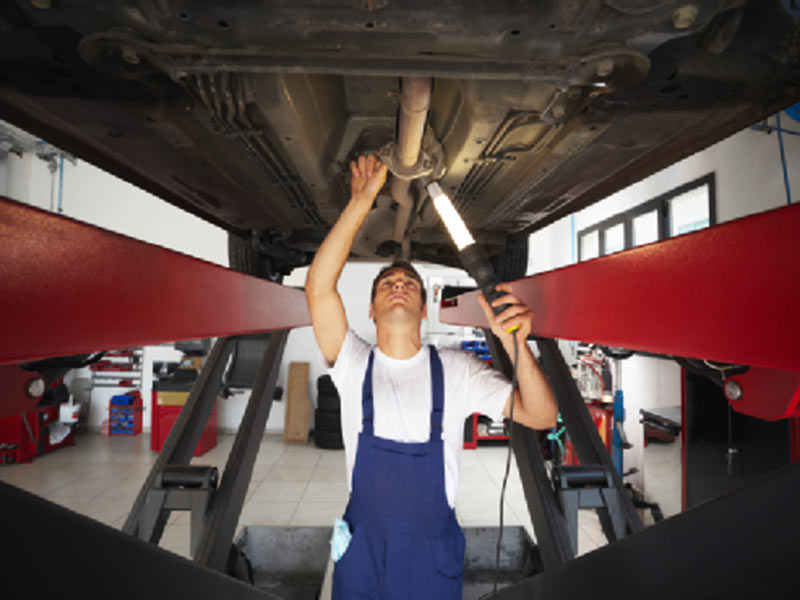 MAN WORKING ON FLOORING OF CAR