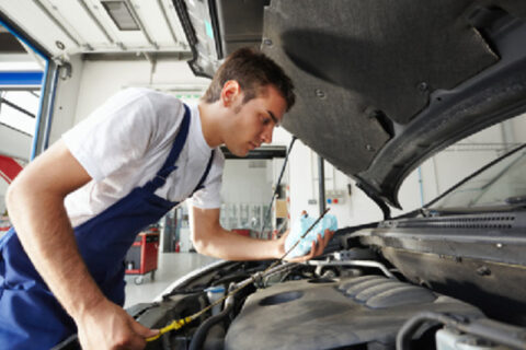 man servicing car