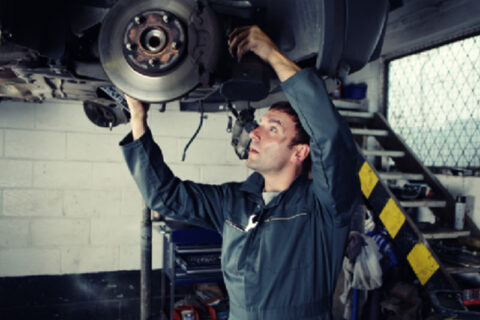 mechanic fixing car flooring