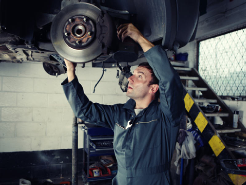 man fixing car flooring