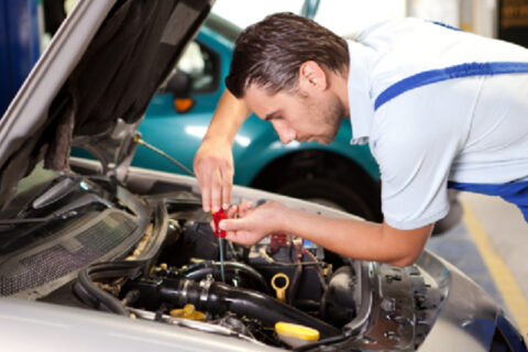man repairing car
