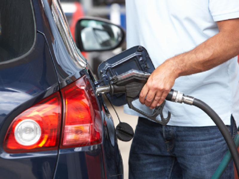 man filling diesel on gas station