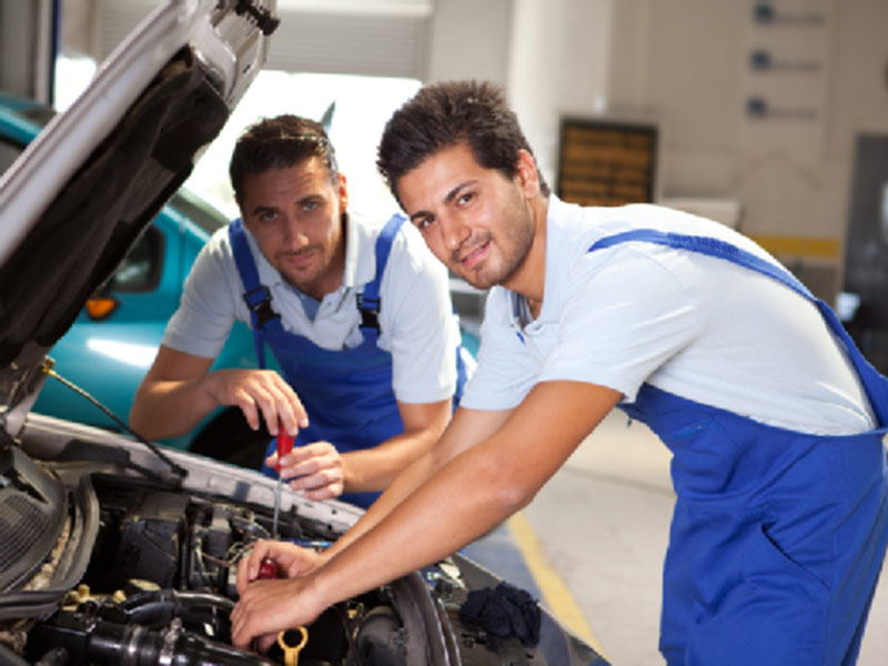 two mechanics fixing car