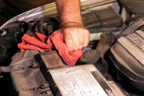 worker cleaning inside of his car using cloth