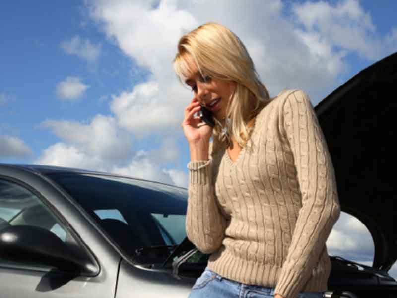 Lady standing besides car