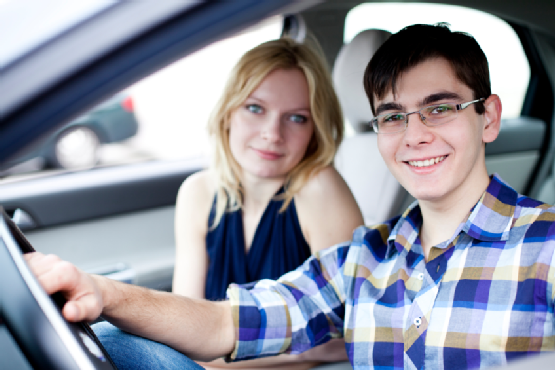 teenage driver posing from inside a car