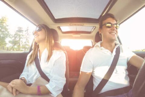 a man and a woman sitting in a car