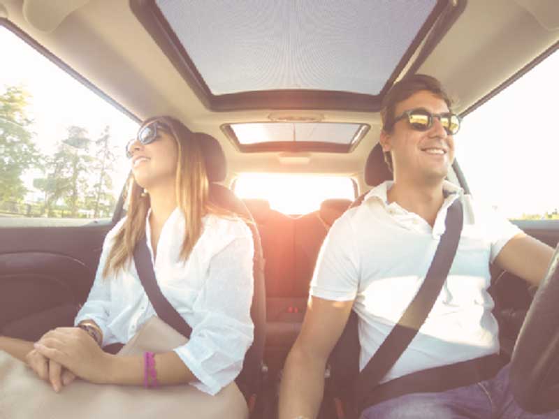 a man and a woman sitting in a car