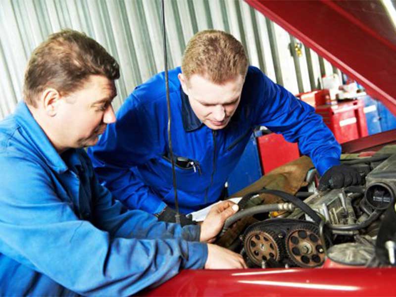 mechanic checking car belt