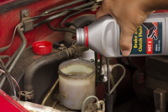 Mechanic pouring oil