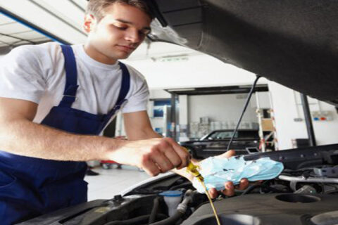 Man replacing the engine oil in car