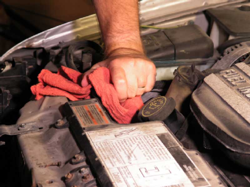 man repairing a car engine