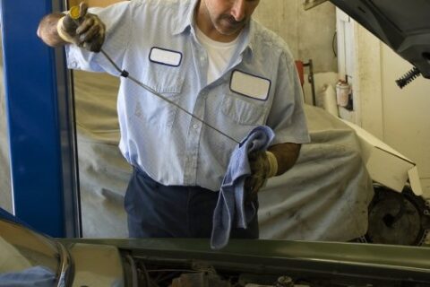 Man checking oil of tank