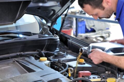 Man changing oil in car