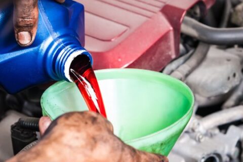 Man changing the oil in car