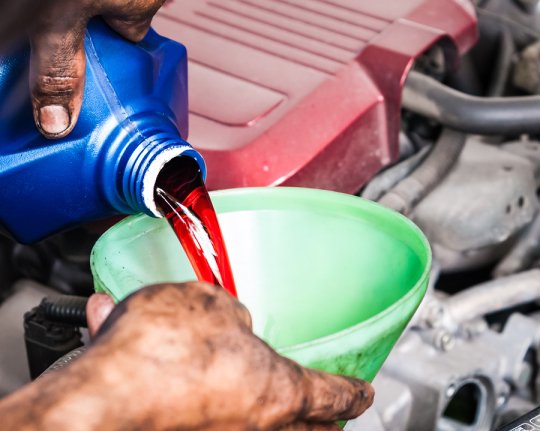 Man changing the oil in car