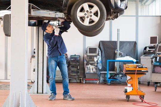 Man repairing tyre of car 